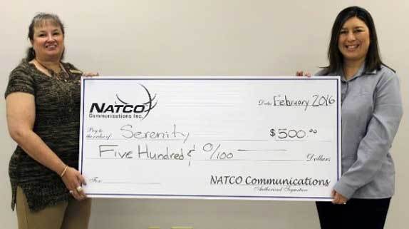 2 women holding a big $500 check